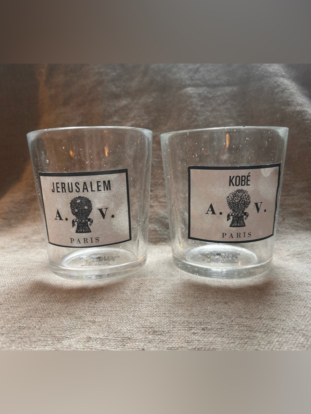 Two empty Astier de Villatte handblown luxury French candle vessels.